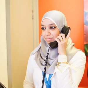 Member of staff on the phone at the desk