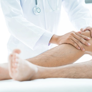 Doctor holding patient's knee