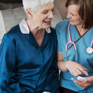 Doctor sits with patient