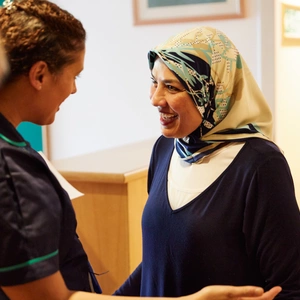A member of staff greeting a patient