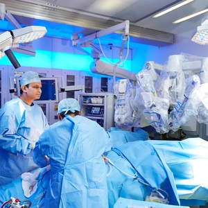 Surgeons using robot in surgery