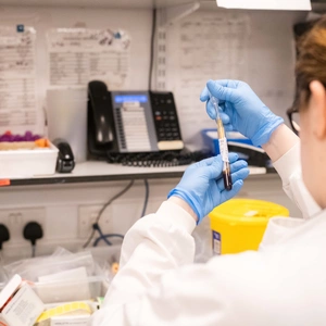 Someone looking at a tube in a lab