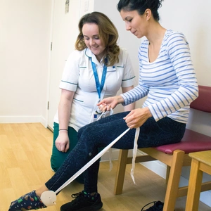 Physio helps patient sitting in chair