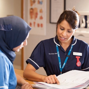 Two nurses going through documents