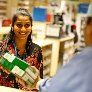 A pharmacist handing over medication