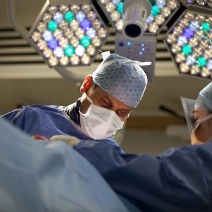 Image of a surgeon completing robotic surgery