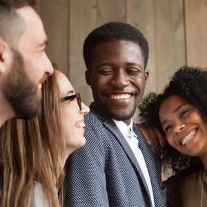 Happy diverse black and white people group with smiling faces bonding together, cheerful african and caucasian young multi ethnic friends having fun laughing embracing, multiracial friendship concept