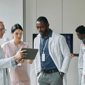 Image of group of doctors gathering around a scan