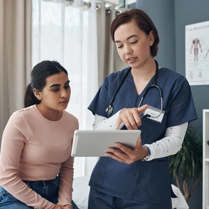 Patient and nurse looking at paperwork together