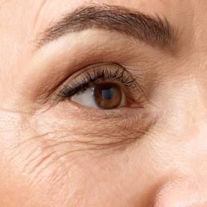 Closeup of middle aged woman eyes. Senior lady looking away, with well-kept and healthy skin.