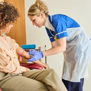 A photo of a patient receiving a treatment, with a nurse providing comfort, at The London Clinic Lung Centre