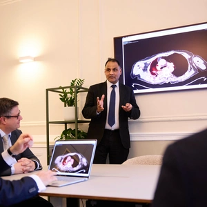 A group of Lung Centre consultants discussing a scan which is seen on the screen
