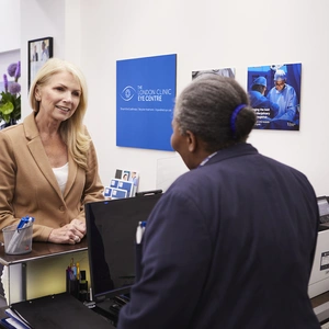 The London Clinic Eye Centre patient being welcomed by the receptionist in Harley Street